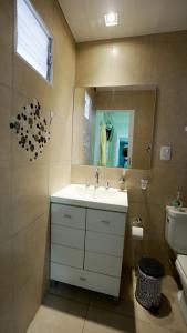 a bathroom with a sink and a mirror and a toilet at ALQUIMIA in Paso de la Patria