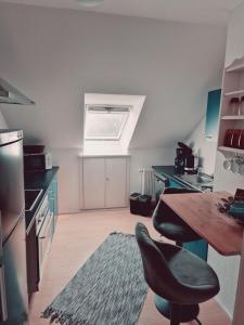 a kitchen with a table and a chair in it at Rosindell Brunnenhaus in Halle Westfalen