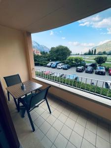 a balcony with a table and a view of a parking lot at Studio de vacances aux Bains de Saillon in Saillon +6 photos