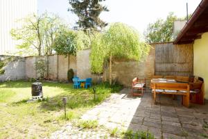 a backyard with a wooden table and chairs at Apartmán Extoll in Třeboň