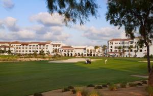 un campo da golf di fronte a un grande edificio di 1 Bedroom Suite @ The address Golf Marassi Resort a El Alamein