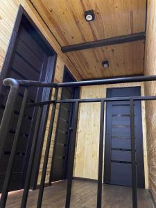 a staircase in a house with a wooden ceiling at Воллен in Zhvanets