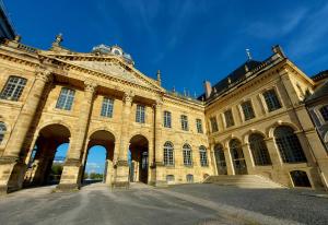 a large stone building with stairs in front of it at ° Studio 1 - Lunéville centre ° in Lunéville