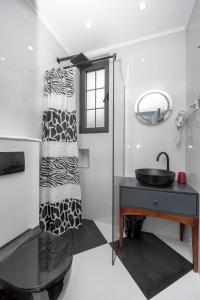 baño con lavabo negro y espejo en Baba's Hotel & Spa en Dobra Voda