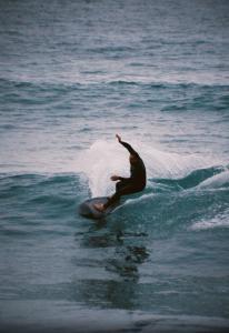 a man riding a wave on a surfboard in the ocean at Onda Surf in Taghazout