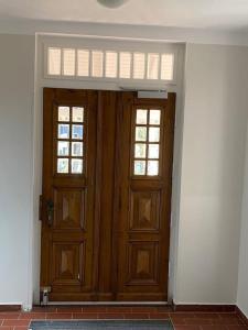 an empty room with two wooden doors with windows at Apartment Nr. 3 Bad Laasphe Altstadt in Bad Laasphe