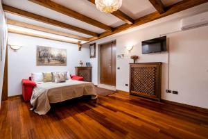 a bedroom with a bed and a television in a room at Dante's Residence in Venice-Lido