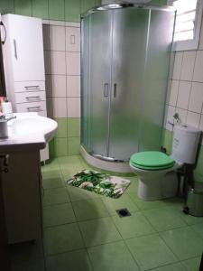 a bathroom with a shower and a toilet and a sink at The Sunny House in Kritharia +35 photos