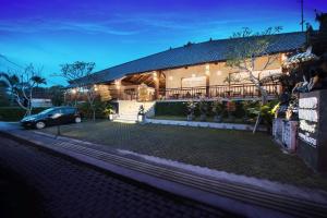 a car parked in front of a building at night at Ubud Wana Resort in Ubud