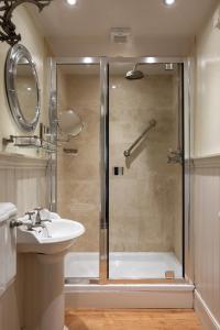 a bathroom with a shower and a sink at The Griffin Inn in Fletching