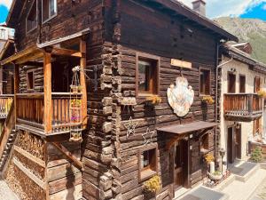 a log cabin with a porch and a balcony at Chalet Nano in Livigno