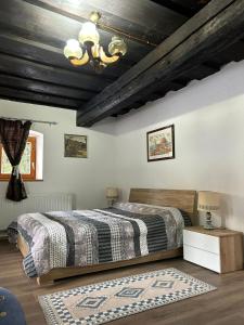 a bedroom with a bed and a wooden ceiling at Blue House in Ramingstein
