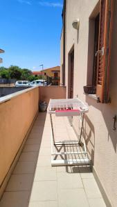 a shopping cart sitting on the side of a balcony at Casa Marsala in Olbia