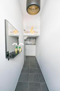 a hallway with a tile floor and a sign for a collagen orange store at Golden Dove Luxury Aparts in Brussels