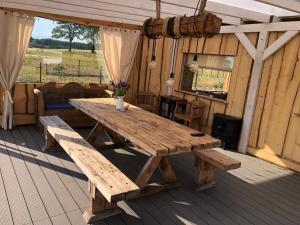 a wooden picnic table sitting on a deck at Radaczowa Chatka 