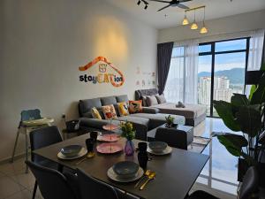 a living room with a couch and a table at Beacon Executive Suite by stayCATion Homestay in George Town