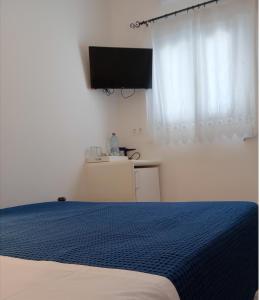 Postel nebo postele na pokoji v ubytování Meltemi Rooms and Studios