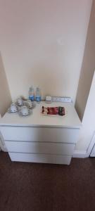 a white table with dishes on top of it at City Centre Ensuite Home - Free parking, near Uni & Hospital in Sunderland