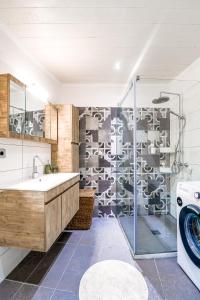 a bathroom with a sink and a washing machine at Moute House by Corfuescapes in Ágioi Doúloi