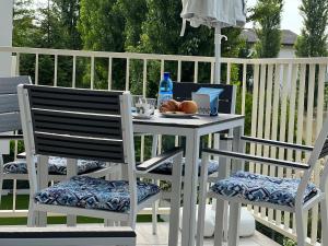 a table and chairs with a plate of food on a patio at Sogno di mare in Cavallino-Treporti