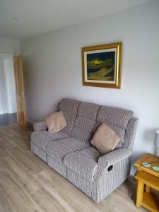 a couch in a living room with a picture on the wall at luxury in Ballyvoy