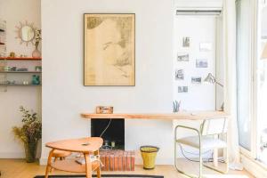 a room with a desk and a table and a chair at Le Gabian in Marseille