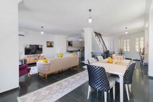 a living room with a table and a couch at Villa ANATOLIAN in Antalya