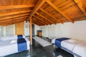 two beds in a room with wooden ceilings at Villa ANATOLIAN in Antalya