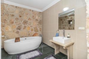 a bathroom with a tub and a sink at Villa ANATOLIAN in Antalya