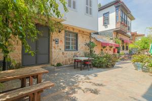 a patio with a table and chairs and a building at Villa ANATOLIAN in Antalya