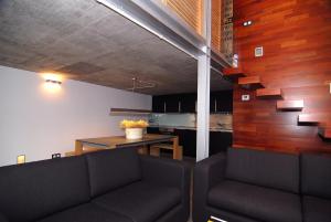 a living room with two couches and a table at Loft Rural Cirueches 19 in Carabias