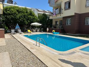 a swimming pool in front of a building at Villa Marla in Side