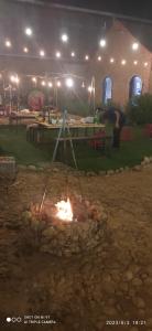 a fire pit with a person in the background at Homestay Hơ Đơng in Pleiku