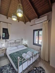 a bedroom with a bed and two lamps and a window at Odysseus Suite in Kiónion