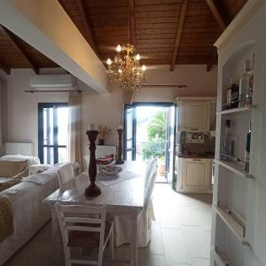 a living room with a table and a couch at Odysseus Suite in Kiónion