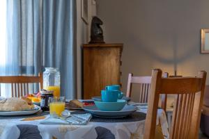 a table with plates of food and orange juice on it at Sun, Sea, Beach Costa Calida Spain Henrys Apartment in Águilas