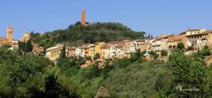a group of buildings on a hill with trees at Casa Duccio in San Miniato