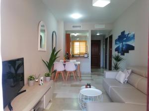 a living room with a couch and a table at CN-340 Suites in Estepona