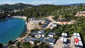 an aerial view of a beach with houses and the water at Mobile Home L&L in Drage