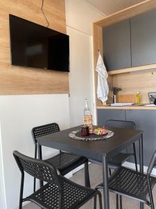 a black table and chairs in a small kitchen at Mobile Home L&L in Drage