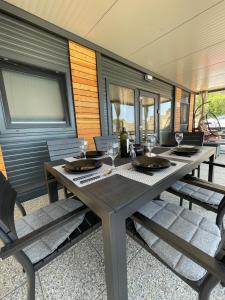a wooden table with wine glasses on a patio at Mobile Home L&L in Drage