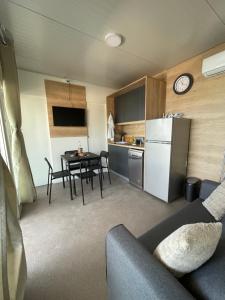a small kitchen with a table and a white refrigerator at Mobile Home L&L in Drage