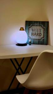 a white vase sitting on a table with a lamp at mandaluyong 2 br condo for rent in Manila