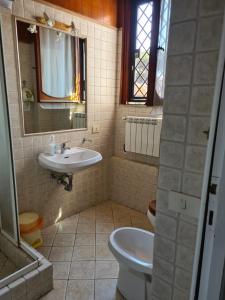 La salle de bains est pourvue d'un lavabo et de toilettes. dans l'établissement La casa di Nataly, à Fregene