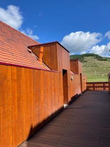 a row of wooden buildings on a boardwalk at Les Appartements du Vignoble in Kientzheim