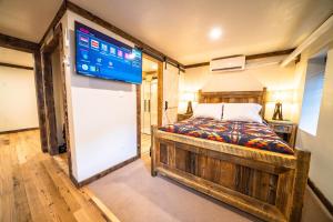 a bedroom with a bed and a large screen at St. Elmo Hotel in Ouray