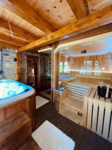 ein großes Holzbadezimmer mit einer Badewanne in einem Zimmer in der Unterkunft Zlatibor Resort & Spa in Zlatibor