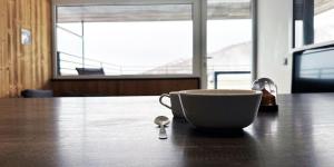 a coffee cup sitting on a table with a spoon at Appartement au pied des pistes in Besse-et-Saint-Anastaise