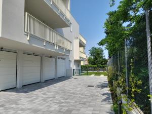 a building with two garage doors and a fence at Ca' Savio terramare in Cavallino-Treporti