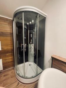 a glass shower in the corner of a room at Appartement Sabrina in Steinberg am Rofan